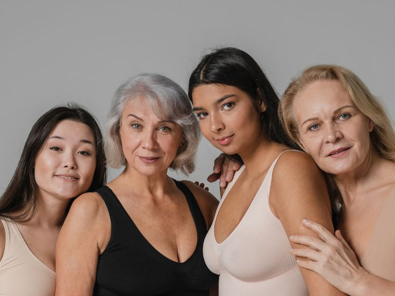 4 women of multiple ages looking at the camara supporting eachother 
