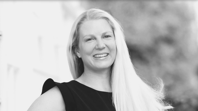 image of Dr Anna Hemming smiling at the camara with her hair down 